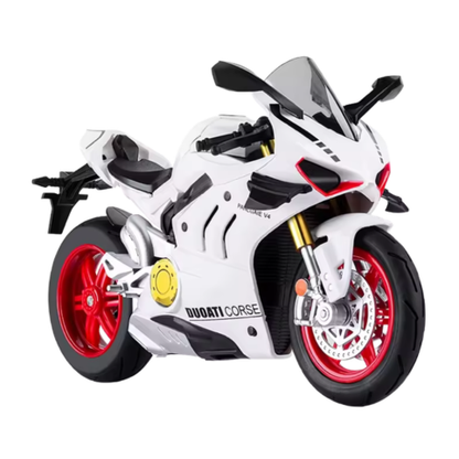 Vit diecast racingmotorcykel med röda fälgar i sned vinkel mot ljus bakgrund