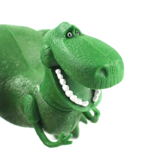 Närbild på huvud och ansikte på grön dinosaurieleksak